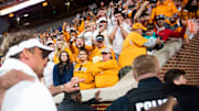 Tennessee fans boo Mississippi Football Coach Lane Kiffin as he's escorted off the field following Tennessee's game against Ole Miss at Neyland Stadium.