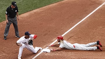 Jul 11, 2021; Boston, Massachusetts, USA; Philadelphia Phillies center fielder Travis Jankowski (9) slides safely into third base as the throw gets by Boston Red Sox third baseman Rafael Devers (11) during the third inning at Fenway Park. Jankowski scored on the play. Mandatory Credit: Winslow Townson-Imagn Images