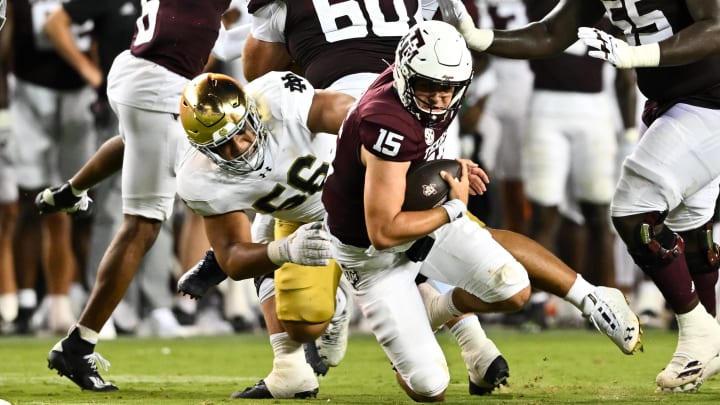 Aug 31, 2024; College Station, Texas, USA; Notre Dame Fighting Irish defensive lineman Howard Cross III (56) tackles Texas A&M Aggies quarterback Conner Weigman (15) at Kyle Field. Mandatory Credit: Maria Lysaker-USA TODAY Sports