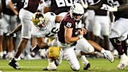 Aug 31, 2024; College Station, Texas, USA; Notre Dame Fighting Irish defensive lineman Howard Cross III (56) tackles Texas A&M Aggies quarterback Conner Weigman (15) at Kyle Field.