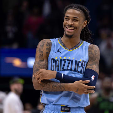 Memphis Grizzlies guard Ja Morant (12) smiles at a fan as the end of regulation against the New Orleans Pelicans at Smoothie King Center. Mandatory Credit: