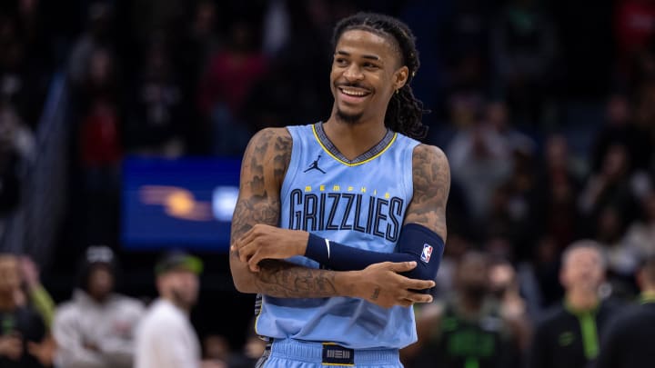 Memphis Grizzlies guard Ja Morant (12) smiles at a fan as the end of regulation against the New Orleans Pelicans at Smoothie King Center. Mandatory Credit: