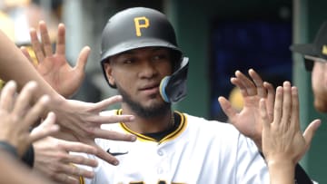 May 26, 2024; Pittsburgh, Pennsylvania, USA;  Pittsburgh Pirates right fielder Edward Olivares (38) high-fives in the dugout after scoring a run against the Atlanta Braves during the second inning at PNC Park. Mandatory Credit: Charles LeClaire-USA TODAY Sports