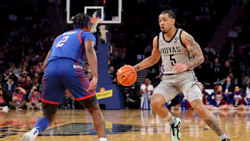 Mar 12, 2025; New York, NY, USA; Georgetown Hoyas guard Micah Peavy (5) controls the ball against DePaul Blue Demons guard Layden Blocker (2) during the second half at Madison Square Garden. Mandatory Credit: Brad Penner-Imagn Images