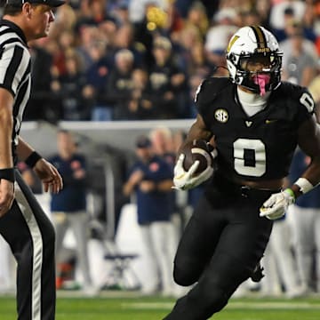 Nov 8, 2025; Nashville, Tennessee, USA;  Vanderbilt Commodores wide receiver Junior Sherrill (0) runs with the ball after a made catch against the Auburn Tigers during the overtime period at FirstBank Stadium. Mandatory Credit: Steve Roberts-Imagn Images