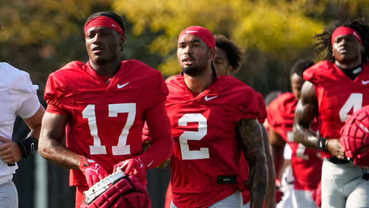 Aug 1, 2024; Columbus, OH, USA; Ohio State Buckeyes wide receivers Carnell Tate (17) and Emeka Egbuka (2) run between drills during football camp at the Woody Hayes Athletic Complex.