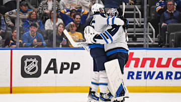 Feb 22, 2025; St. Louis, Missouri, USA; Winnipeg Jets goaltender Eric Comrie (1) celebrates with teammates after beating the St. Louis Blues in a shootout at Enterprise Center. Mandatory Credit: Connor Hamilton-Imagn Images