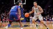 Mar 12, 2025; New York, NY, USA; Georgetown Hoyas guard Micah Peavy (5) controls the ball against DePaul Blue Demons guard Layden Blocker (2) during the second half at Madison Square Garden. Mandatory Credit: Brad Penner-Imagn Images