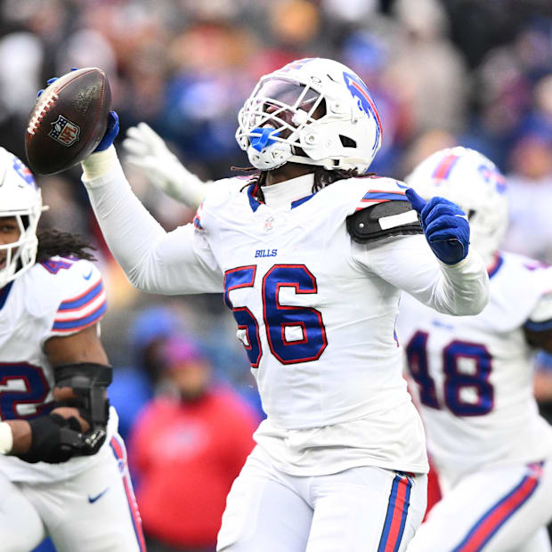 Buffalo Bills defensive end Javon Solomon recovers a fumble during a game against the New England Patriots.