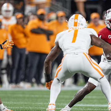 Sep 7, 2024; Charlotte, North Carolina, USA; North Carolina State Wolfpack wide receiver Dacari Collins (4) runs with the ball as Tennessee Volunteers defensive back Rickey Gibson III (1) defends during the first quarter at the Dukes Mayo Classic at Bank of America Stadium. Mandatory Credit: Jim Dedmon-Imagn Images