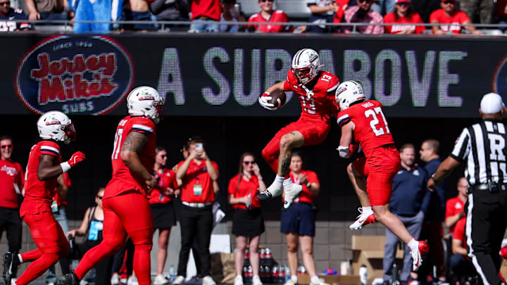 Oct 19, 2024; Tucson, Arizona, USA; Arizona Wildcats defensive back Jack Luttrell (13) celebrates after making an interception against the Colorado Buffaloes during the second quarter at Arizona Stadium. Mandatory Credit: Aryanna Frank-Imagn Images