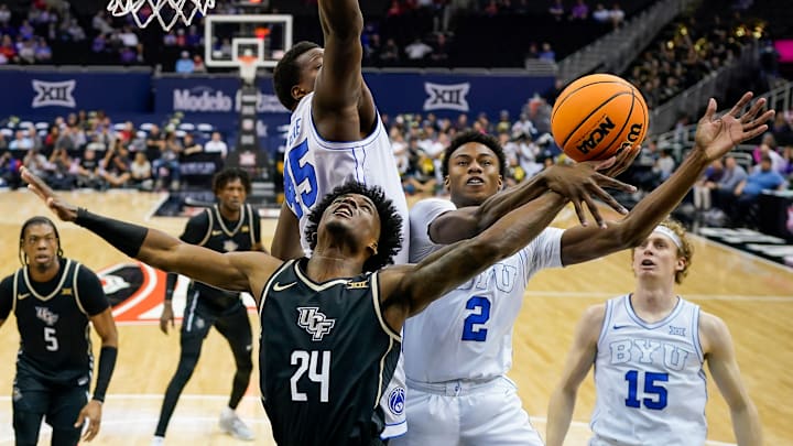 Jaxson Robinson and Fousseyni Traore contest a shot from UCF's Jaylin Sellers