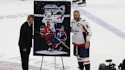 Apr 6, 2025; Elmont, New York, USA;  Washington Capitals left wing Alex Ovechkin (8) is honored with a painting by artist Tony Harris by former Canadian-American ice hockey player Wayne Gretzky after scoring in the during the second period against the New York Islanders at UBS Arena. Ovechkin scored the 895th goal of his career, breaking the NHL all-time career goals record previously held by Wayne Gretzky at UBS Arena. Mandatory Credit: Geoff Burke-Imagn Images