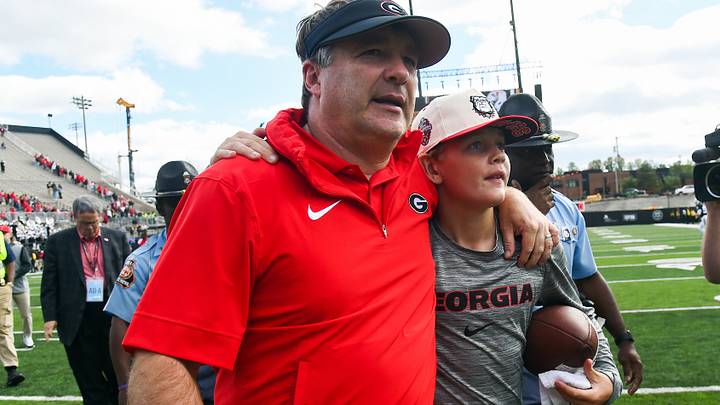 Oct 14, 2023; Nashville, Tennessee, USA; Georgia Bulldogs head coach Kirby Smart leaves the field with his son Andrew after a win against the Vanderbilt Commodores at FirstBank Stadium. Mandatory Credit: Christopher Hanewinckel-USA TODAY Sports