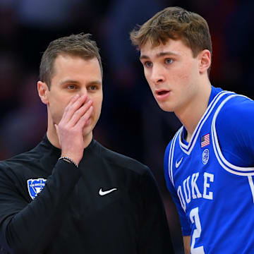 Feb 5, 2025; Syracuse, New York, USA; Duke Blue Devils head coach Jon Scheyer talks with guard Cooper Flagg (2) against the Syracuse Orange during the first half at the JMA Wireless Dome. Mandatory Credit: Rich Barnes-Imagn Images
