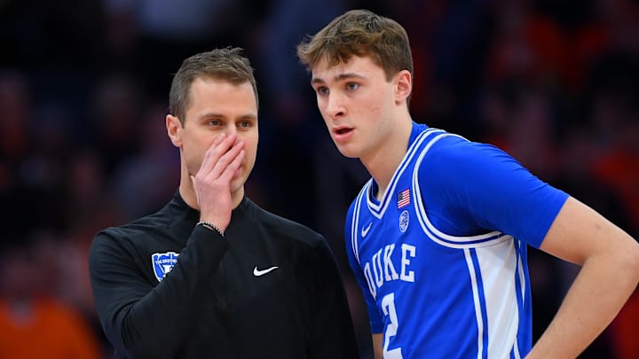 Feb 5, 2025; Syracuse, New York, USA; Duke Blue Devils head coach Jon Scheyer talks with guard Cooper Flagg (2) against the Syracuse Orange during the first half at the JMA Wireless Dome. Mandatory Credit: Rich Barnes-Imagn Images