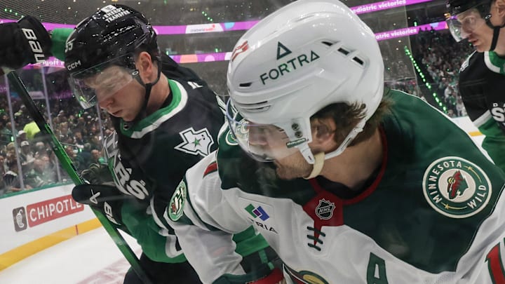Apr 18, 2026; Dallas, Texas, USA; Dallas Stars defenseman Thomas Harley (55)and Minnesota Wild left wing Marcus Foligno (17) battle for the puck in the corner in the first period in game one of the first round of the 2026 Stanley Cup Playoffs at American Airlines Center. Mandatory Credit: Thomas Shea-Imagn Images