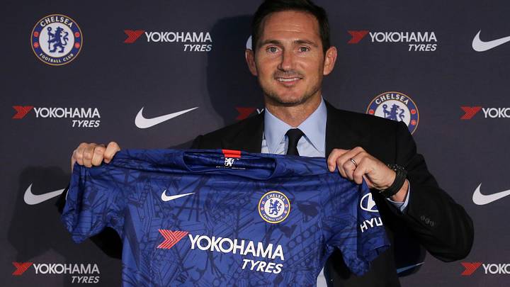 Former Chelsea manager Frank Lampard holds up the team jersey.