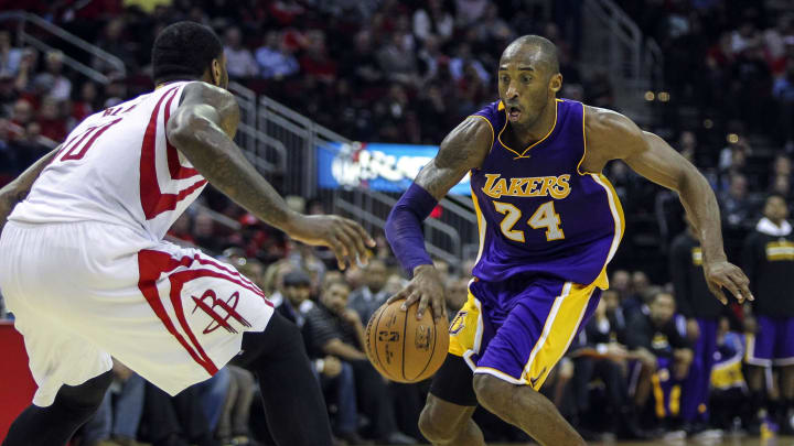 Nov 19, 2014; Houston, TX, USA; Los Angeles Lakers guard Kobe Bryant (24) controls the ball during the third quarter as Houston Rockets forward Tarik Black (10) defends at Toyota Center. Mandatory Credit: Troy Taormina-USA TODAY Sports