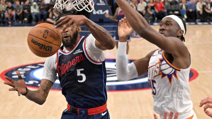 Oct 24, 2025; Inglewood, California, USA; Los Angeles Clippers forward John Collins (20) and Phoenix Suns center Mark Williams (15) reach for a rebound in the second half at Intuit Dome. Mandatory Credit: Jayne Kamin-Oncea-Imagn Images