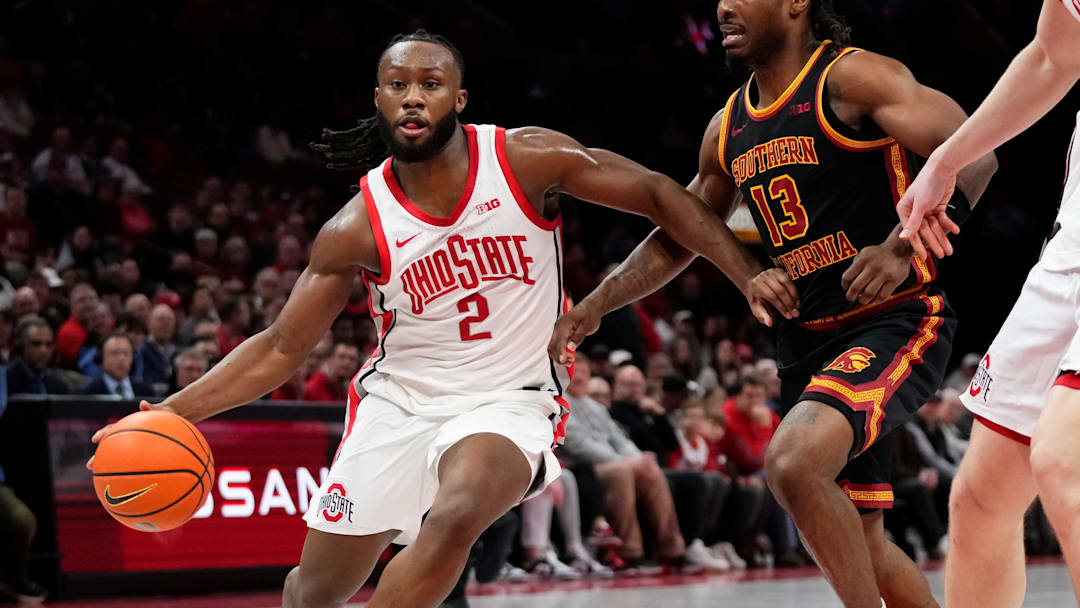 Ohio State Buckeyes guard Bruce Thornton (2) drives past USC Trojans guard Kam Woods (13) during the first half of the NCAA men's basketball game at the Schottenstein Center on Feb. 11, 2026.