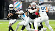 Oct 12, 2025; Paradise, Nevada, USA; Las Vegas Raiders quarterback Geno Smith (7) is sacked by Tennessee Titans linebacker Dre'Mont Jones (45) during the second half at Allegiant Stadium. Mandatory Credit: Stephen R. Sylvanie-Imagn Images