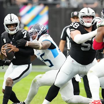 Oct 12, 2025; Paradise, Nevada, USA; Las Vegas Raiders quarterback Geno Smith (7) is sacked by Tennessee Titans linebacker Dre'Mont Jones (45) during the second half at Allegiant Stadium. Mandatory Credit: Stephen R. Sylvanie-Imagn Images