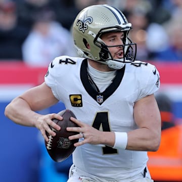 Dec 8, 2024; East Rutherford, New Jersey, USA; New Orleans Saints quarterback Derek Carr (4) drops back to pass against the New York Giants during the first quarter at MetLife Stadium. Mandatory Credit: Brad Penner-Imagn Images