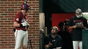 Apr 24, 2025; Tuscaloosa, AL, USA; Alabama head coach Rob Vaughn talks to Alabama infielder Garrett Staton (27) who is on deck to hit against Missouri at Sewell-Thomas Stadium.