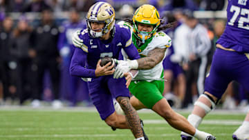 Oregon outside linebacker Matayo Uiagalelei, right, pressures Washington quarterback Demond Williams Jr. as the Oregon Ducks take on the Washington Huskies on Nov. 29, 2025, at Husky Stadium in Seattle, Washington.