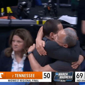 Houston head coach Kelvin Sampson and assistant Kellen Sampson embrace after win over Tennessee in Elite Eight.