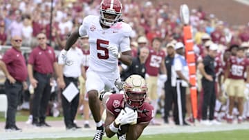 Aug 30, 2025; Tallahassee, Florida, USA; Florida State Seminoles wide receiver Squirrel White (4) makes a catch against Alabama Crimson Tide defensive back Dijon Lee Jr. (5) during the first half at Doak S. Campbell Stadium. Mandatory Credit: Melina Myers-Imagn Images