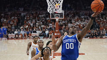 Feb 15, 2025; Austin, Texas, USA; Kentucky Wildcats guard Otega Oweh (0) lays in a basket ahead of Texas Longhorns guard Tre Johnson (20) during the first half at Moody Center. Mandatory Credit: Scott Wachter-Imagn Images