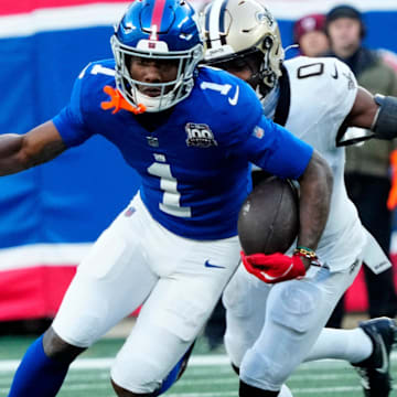 New York Giants wide receiver Malik Nabers (1) runs with the ball, as New Orleans Saints safety Ugo Amadi (0) tries to catch him, Sunday, December 8, 2024.