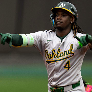 Oakland Athletics right fielder Lawrence Butler (4) gestures to the dugout as he rounds third base after hitting a solo home run in the first inning of the MLB game between the Cincinnati Reds and Oakland Athletics at Great American Ball Park in Cincinnati on Wednesday, Aug. 28, 2024.