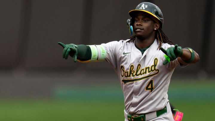 Oakland Athletics right fielder Lawrence Butler (4) gestures to the dugout as he rounds third base after hitting a solo home run in the first inning of the MLB game between the Cincinnati Reds and Oakland Athletics at Great American Ball Park in Cincinnati on Wednesday, Aug. 28, 2024.