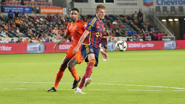 Aug 5, 2024; Houston, Texas, USA; Real Salt Lake midfielder Bode Hidalgo (19) kicks the ball past Houston Dynamo FC defender Micael dos Santos (31) in the second half at Shell Energy Stadium. Mandatory Credit: Sean Thomas-USA TODAY Sports