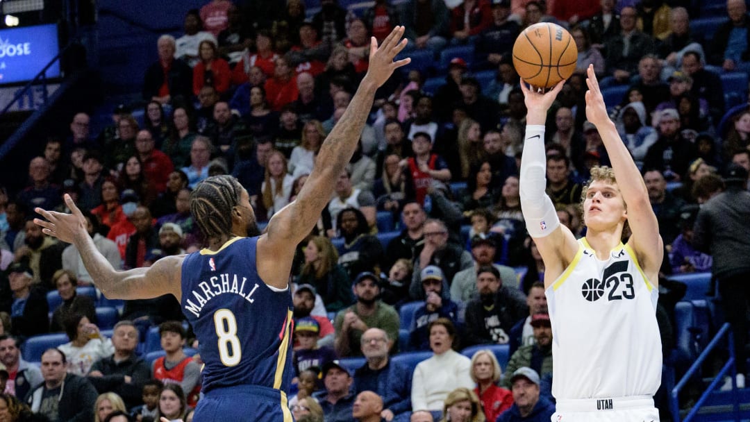 Dec 28, 2023; New Orleans, Louisiana, USA; Utah Jazz forward Lauri Markkanen (23) shoots against New Orleans Pelicans forward Naji Marshall (8) during the second half at the Smoothie King Center. 