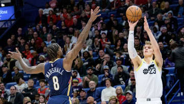 Dec 28, 2023; New Orleans, Louisiana, USA; Utah Jazz forward Lauri Markkanen (23) shoots against New Orleans Pelicans forward Naji Marshall (8) during the second half at the Smoothie King Center. 