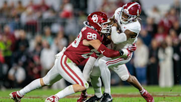 Alabama Crimson Tide quarterback Jalen Milroe (4) is tackled by Oklahoma Sooners linebacker Danny Stutsman (28) 