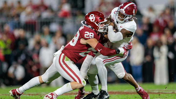 Alabama Crimson Tide quarterback Jalen Milroe (4) is tackled by Oklahoma Sooners linebacker Danny Stutsman (28) 