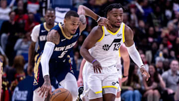 Jan 17, 2025; New Orleans, Louisiana, USA; New Orleans Pelicans guard Dejounte Murray (5) brings the ball up court against Utah Jazz guard Isaiah Collier (13) during the first half at Smoothie King Center. Mandatory Credit: Stephen Lew-Imagn Images