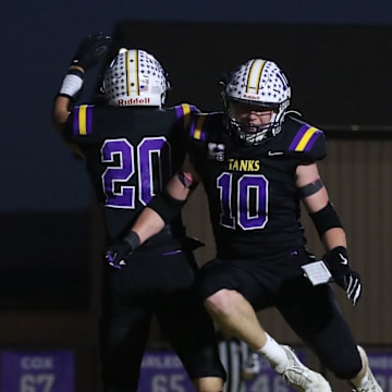 Unioto's Cody Braden (20) celebrates a touchdown with David Long (10). Unioto defeated Paint Valley 43-0 on Friday, Oct. 18. 2024 at Unioto High School. The win earned them at least a share of the Scioto Valley Conference title.