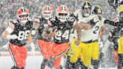 Nick Chubb scores a touchdown in the snow at Huntington Bank Field in Cleveland.