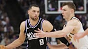 Apr 9, 2025; Sacramento, California, USA; Sacramento Kings guard Zach LaVine (8) controls the ball against Denver Nuggets guard Christian Braun (0) during the third quarter at Golden 1 Center.