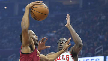 Apr 8, 2025; Cleveland, Ohio, USA; Cleveland Cavaliers forward Isaac Okoro (35) drives to the basket beside Chicago Bulls forward Jalen Smith (7) in the first quarter at Rocket Arena. Mandatory Credit: David Richard-Imagn Images
