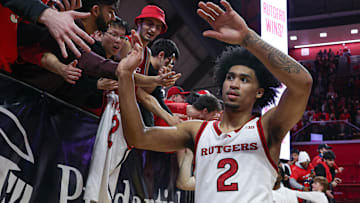 Mar 9, 2025; Piscataway, New Jersey, USA; Rutgers Scarlet Knights guard Dylan Harper (2) slap hands with fans after the game against the Minnesota Golden Gophers at Jersey Mike's Arena. Mandatory Credit: Vincent Carchietta-Imagn Images