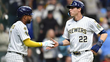 Apr 20, 2025; Milwaukee, Wisconsin, USA; Milwaukee Brewers left fielder Christian Yelich (22) and right fielder Jackson Chourio (11) celebrate after scoring during the seventh inning against the Athletics at American Family Field. Mandatory Credit: Patrick Gorski-Imagn Images
