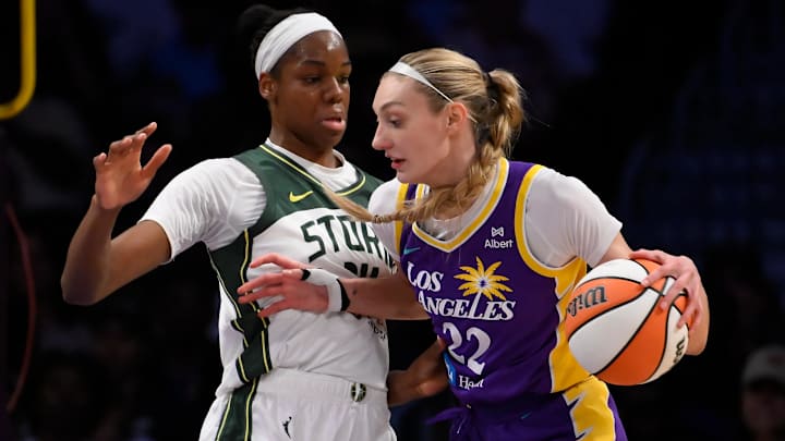 Aug 10, 2025; Los Angeles, California, USA; Los Angeles Sparks forward Cameron Brink (22) drives to the basket defended by Seattle Storm center Dominique Malonga (14) during the second quarter at Crypto.com Arena. Mandatory Credit: Robert Hanashiro-Imagn Images