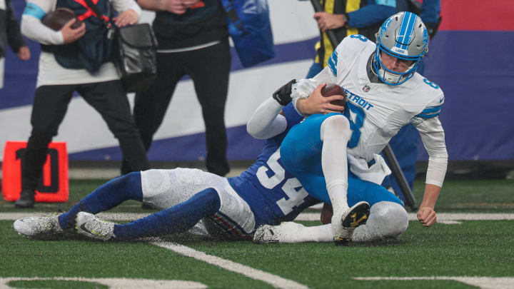 Aug 8, 2024; East Rutherford, New Jersey, USA; New York Giants linebacker Dyontae Johnson (54) sacks Detroit Lions quarterback Nate Sudfeld (8) during the first quarter at MetLife Stadium.  